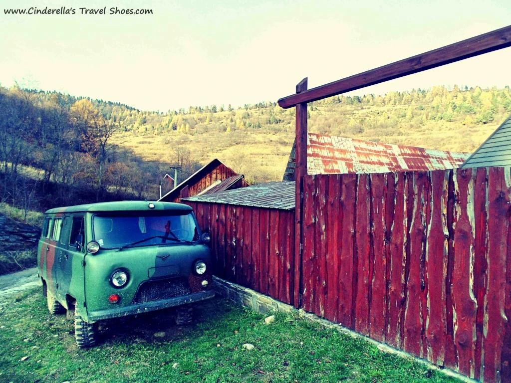 The car with army look in from of the wooden house in Lacnov